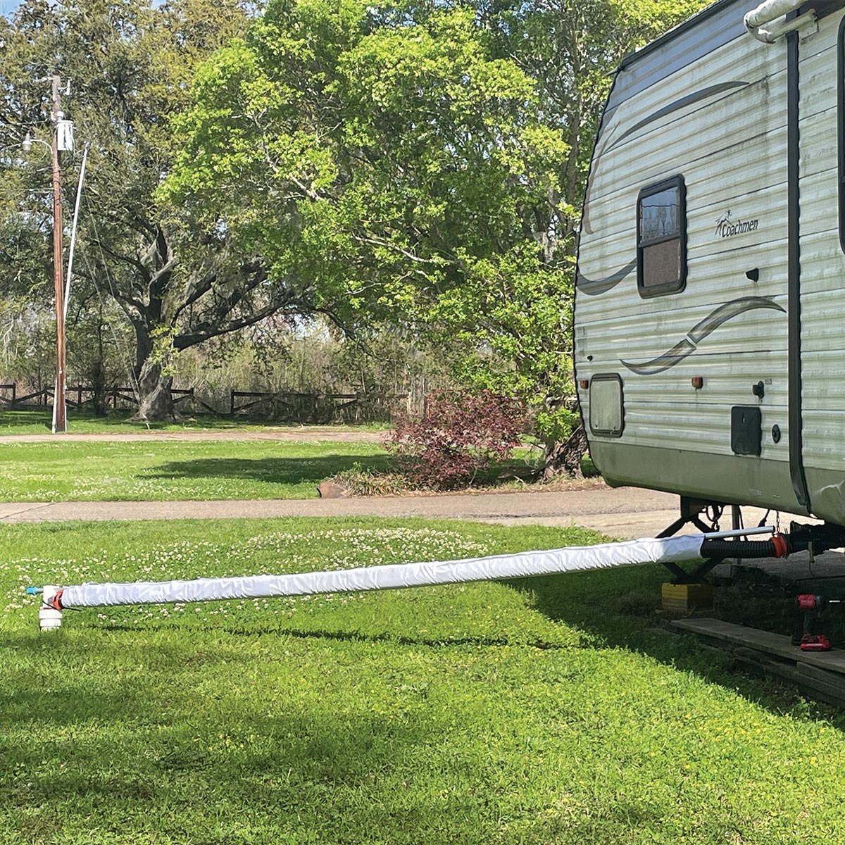 15 ft Levitator holding a covered RV sewer hose level from the camper to the drain